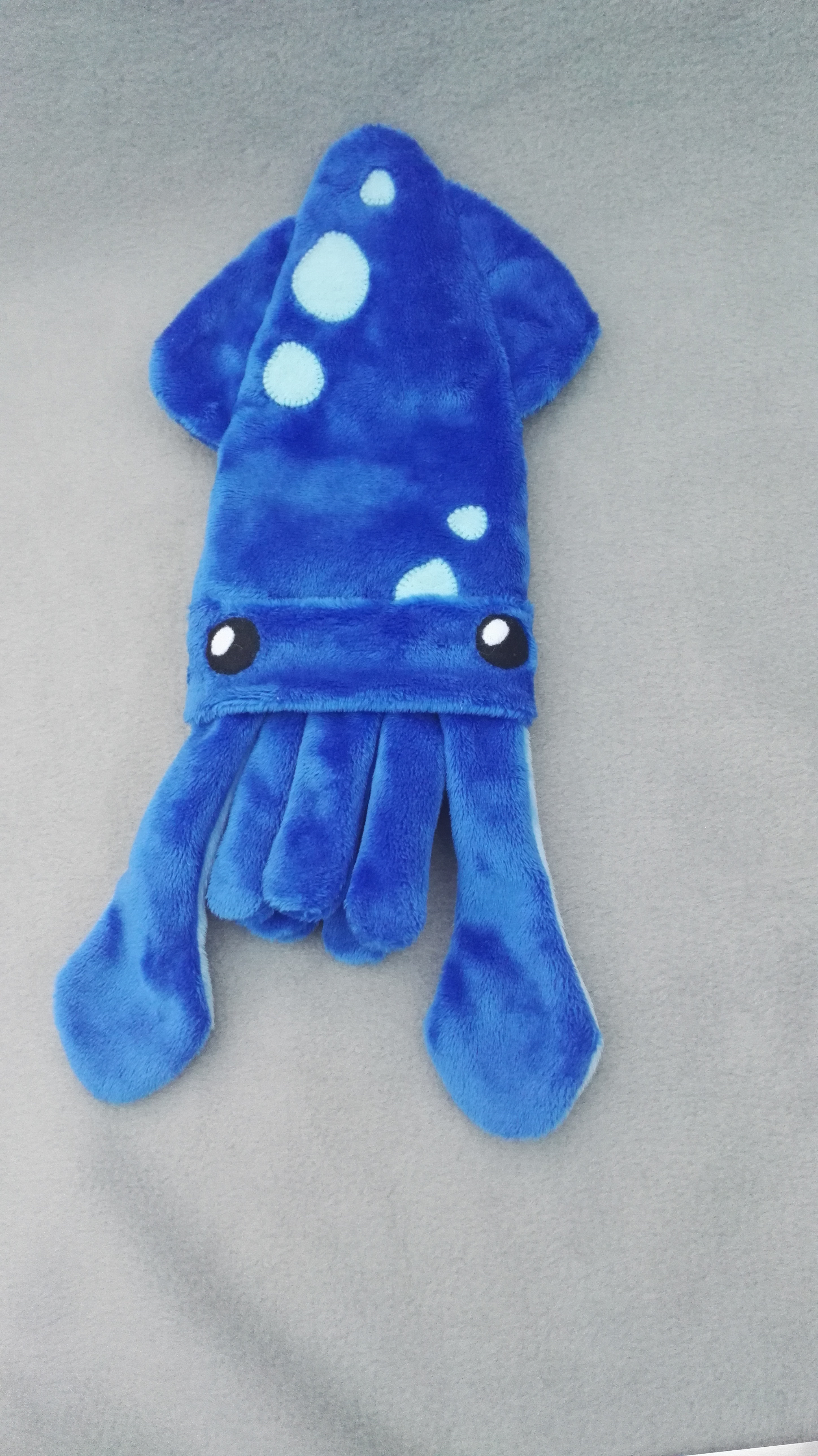 a blue squid pencil case with light blue details and eyes